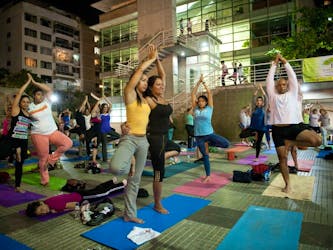 People practise yoga in a public square in Caracas, Venezuela in this file photo. Outdoor workouts feel less strenuous than those done in the gym, writes columnist Jill Barker.