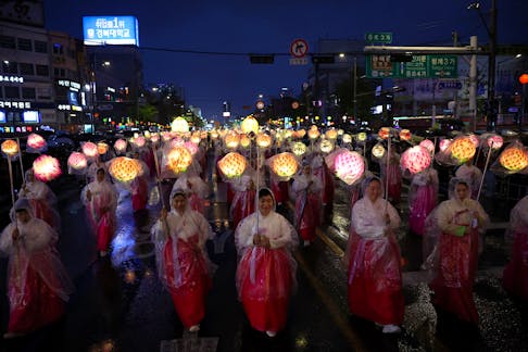 Buddhist believers march with lanterns during a Lotus Lantern parade in celebration of the upcoming birthday of Buddha, in Seoul, South Korea, May 11, 2024.   