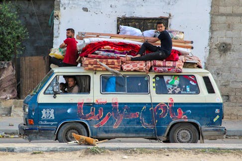 Displaced Palestinians travel in a vehicle as they flee Rafah, after Israeli forces launched a ground and air operation in the eastern part of the southern Gaza city, amid the ongoing conflict between Israel and Hamas, in Rafah, in the southern Gaza Strip May 12, 2024.