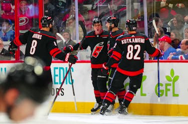 May 11, 2024; Raleigh, North Carolina, USA; Carolina Hurricanes center Evgeny Kuznetsov (92) celebrates with defenseman Brent Burns (8) and defenseman Jaccob Slavin (74) and center Jesperi Kotkaniemi (82) after scoring a goal against the New York Rangers during the first period in game four of the second round of the 2024 Stanley Cup Playoffs at PNC Arena. Mandatory Credit: James Guillory-USA TODAY Sports