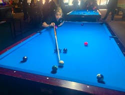 Lynn Gould of the Aunties team uses the rake to line up a shot at the 10-ball during the April Denny Memorial Tournament at Dooly’s pool and billiard hall in Sydney on Sunday. Teams and individual players from across the Maritimes took part in the weekend-long event in memory of Denny, a 19-year-old Eskasoni pool enthusiast who died suddenly of heart failure. CHRIS CONNORS/CAPE BRETON POST