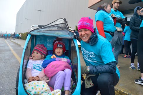 Rachael Germani unzipped the rain cover protecting daughters Raya, 2, and Wylie, 5, from the wet weather Sunday as they attended the Teal to Heal Mother’s Day Run in Membertou. Hundreds attended the annual walk-and-run fundraiser in support of ovarian cancer. The event held at the Membertou Sport and Wellness Centre also featured a wellness expo and live entertainment. Since it was launched in 2022 by Dena Edwards Wadden, who was diagnosed with ovarian cancer at age 33, Teal to Heal has raised more than $200,000 for the Teal at Home Fund offered through the Cape Breton Regional Hospital Foundation and is recognized as the largest fundraiser and awareness campaign for for gynecological cancer in Canada. CHRIS CONNORS/CAPE BRETON POST