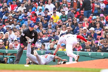 May 12, 2024; Boston, Massachusetts, USA; Boston Red Sox first baseman Garrett Cooper (28) tags Washington Nationals designated hitter Nick Senzel (13) out during the seventh inning at Fenway Park. Mandatory Credit: Eric Canha-USA TODAY Sports