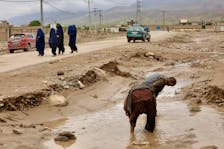 People clean up the area in the aftermath of floods following heavy rain, in Sheikh Jalal District, Baghlan province, Afghanistan May 11, 2024.