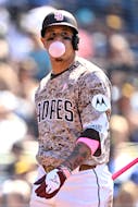 May 12, 2024; San Diego, California, USA; San Diego Padres third baseman Manny Machado (13) blows a bubble-gum bubble after striking out during the seventh inning against the Los Angeles Dodgers at Petco Park. Mandatory Credit: Orlando Ramirez-USA TODAY Sports