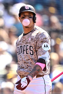 May 12, 2024; San Diego, California, USA; San Diego Padres third baseman Manny Machado (13) blows a bubble-gum bubble after striking out during the seventh inning against the Los Angeles Dodgers at Petco Park. Mandatory Credit: Orlando Ramirez-USA TODAY Sports