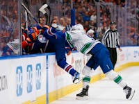 EDMONTON, ALBERTA - MAY 12: Evander Kane #91 of the Edmonton Oilers is checked by Nikita Zadorov #91 of the Vancouver Canucks during the second period in Game Three of the Second Round of the 2024 Stanley Cup Playoffs at Rogers Place on May 12, 2024 in Edmonton, Alberta.