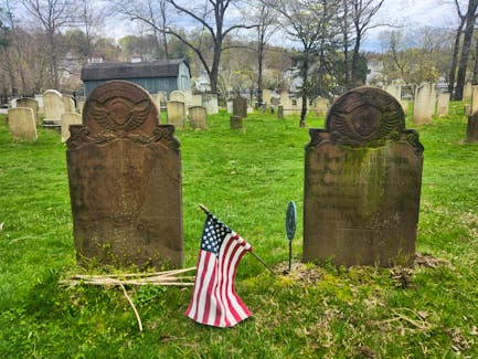 Van Tassel Patriot graves marked with American Flags at the Old Dutch Church Cemetery in Sleepy Hollow, New York. - Katy Jean