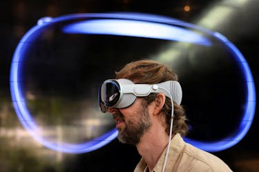 A customer uses Apple's Vision Pro headset on the day it goes on sale for the first time in Los Angeles, California, U.S., February 2, 2024.