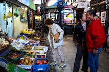 A shopper looks at produce in a market, as Argentina is battling inflation that is running on an annual basis above 275%, in Buenos Aires, Argentina, April 11, 2024.