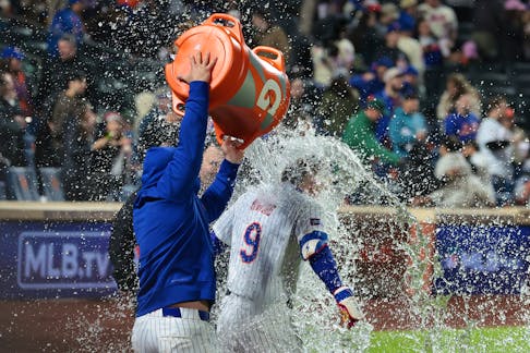 May 12, 2024; New York City, New York, USA; New York Mets left fielder Brandon Nimmo (9) is splashed with a gatorade shower after hitting a walk-off two run home run to defeat the Atlanta Braves at Citi Field. Mandatory Credit: Vincent Carchietta-USA TODAY Sports