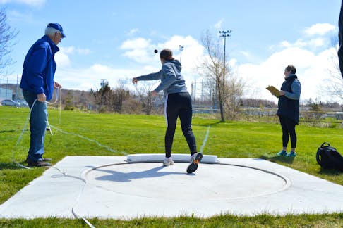 Ella Mills, centre, launches a shot put attempt during Monday morning track and field competitions at Atlantic Street Field in Sydney. Mills is a Sherwood Park Education Centre student.