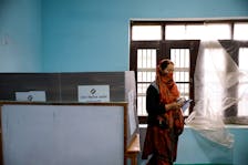A woman leaves after voting at a polling station, during the fourth general election phase, in south Kashmir's Pulwama district, May 13, 2024.
