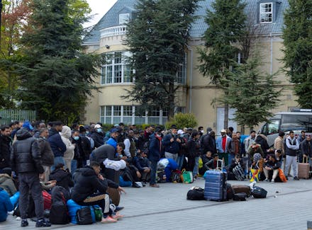 Asylum seekers that were moved from tents camped outside the International Protection Office (IPO) in Dublin City Centre queue to be processed at an International Protection Accommodation Service (IPAS) site providing accommodation, in Citywest, Ireland, May 1, 2024.