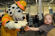 Sparky gets a cookie
St. John’s Regional Fire Department mascot Sparky is excited to be offered a cookie by two-year-old Clara Templeton, daughter of Christina Templeton of St. John’s, at the Old Navy Super Safety Event on Saturday, May 11, 2024 at the Avalon Mall. The day is aimed at promoting child safety in communities across the country by inspiring families to be more safety conscious, and to understand the risks their kids might face and know the steps that can be taken to avoid the risks. — Photo by Joe Gibbons/The Telegram