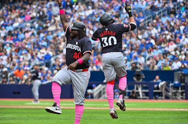May 12, 2024; Toronto, Ontario, CAN;  Minnesota Twins first baseman Carlos Santana (30) celebrates with third base coach Tommy Watkins (40) after hitting a three run home run against the Toronto Blue Jays in the seventh inning at Rogers Centre. Mandatory Credit: Dan Hamilton-USA TODAY Sports