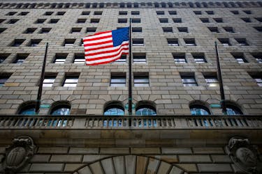The U.S. flag flies outside The Federal Reserve Bank of New York in New York City, U.S., October 12, 2021. 