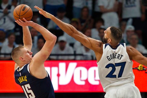 May 12, 2024; Minneapolis, Minnesota, USA; Denver Nuggets center Nikola Jokic (15) shoots against Minnesota Timberwolves forward Karl-Anthony Towns (32) in the fourth quarter of game four of the second round for the 2024 NBA playoffs at Target Center. Mandatory Credit: Bruce Kluckhohn-USA TODAY Sports
