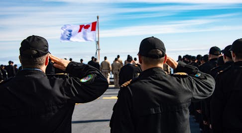 Coxswain, Petty Officer 1st Class Patrick Mackey and Commander Andrew Graham, Commanding Officer of HMCS FREDERICTON, salute the Canadian flag on the flight deck during the Battle of Britain ceremony on September 13, 2021, off the coast of Scotland. Photo: Cpl Laura Landry, Canadian Armed Forces