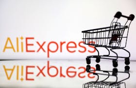 Shopping trolley is seen in front of AliExpress logo in this illustration, July 24, 2022.