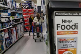 People shop inside a Walmart department store in Westbury, New York, U.S., November 15, 2023. 