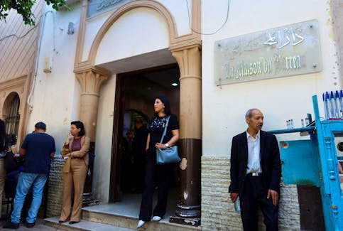 A woman walks out of the building of the Deanship of Lawyers in Tunis, Tunisia May 13, 2024.