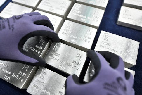 An employee holds an ingot of 99.98 percent pure platinum in a workroom during production at Krastsvetmet precious metals plant in the Siberian city of Krasnoyarsk, Russia, January 31, 2023.