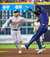 May 13, 2024; Houston, Texas, USA; Houston Astros left fielder Yordan Alvarez (44) is tagged out by Oakland Athletics shortstop Max Schuemann (12) in a run down in the sixth inning at Minute Maid Park. Mandatory Credit: Thomas Shea-USA TODAY Sports
