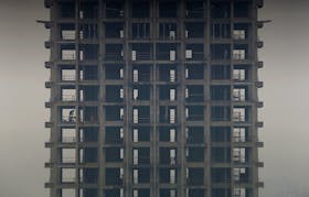 A labourer works on a construction site of a residential building during a hazy day in Hangzhou, Zhejiang province, March 17, 2013.