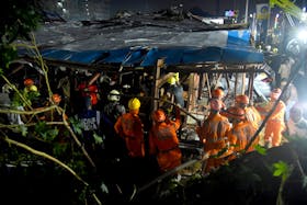 Members of rescue teams search for survivors amidst the debris after a massive billboard fell during a rainstorm in Mumbai, India, May 13, 2024.