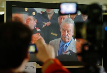 Journalists watch a TV screen inside the media tent as 73-year-old Austrian Josef Fritzl appears in court on the fourth day of his trial in St. Poelten March 19, 2009.