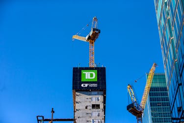 A sign for TD Canada Trust and Cadillac Fairview sit atop a construction project in Toronto, Ontario, Canada December 13, 2021. 