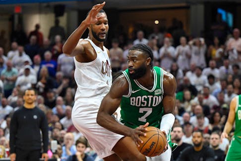 May 13, 2024; Cleveland, Ohio, USA; Boston Celtics guard Jaylen Brown (7) looks to pass beside Cleveland Cavaliers forward Evan Mobley (4) in the second quarter of game four of the second round for the 2024 NBA playoffs at Rocket Mortgage FieldHouse. Mandatory Credit: David Richard-USA TODAY Sports
