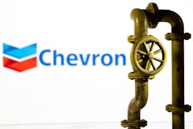 A 3D printed natural gas pipeline is placed in front of displayed Chevron logo in this illustration taken February 8, 2022.