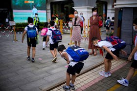 Students bow as they enter a school, as schools reopen following months of closure since the coronavirus disease (COVID-19) outbreak in Shanghai, China, September 1, 2022.