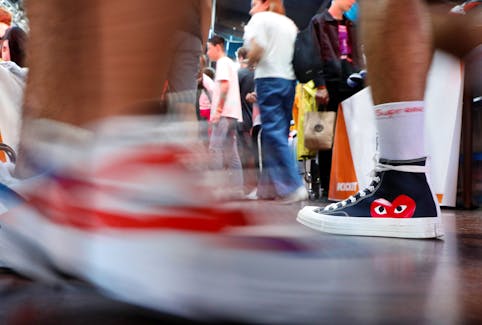 A man walks wearing a limited edition of Converse Chuck Taylor All Star Õ70 sneakers at the KICKIT Sneaker e Streetwear Market in Rome, Italy, September 23, 2018. Picture taken September 23, 2018.  