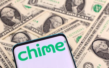The Chime logo is seen on a smartphone placed on U.S. dollars banknotes in this illustration taken January 24, 2022.