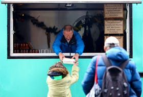 A person in need receives a hot meal from the Caritas Foodtruck in Berlin, Germany December 6, 2022.