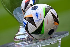 Soccer Football - Euro 2024 - Trophy Display at Allianz Arena, Munich, Germany - May 13, 2024 General view of the Fussballliebe match ball on display next to the European Championship trophy during the presentation