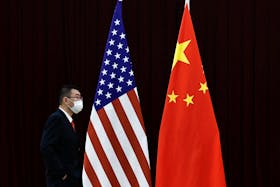 A man walks past the national flags of China and the U.S. before a meeting between China's Vice Premier He Lifeng and U.S. Treasury Secretary Janet Yellen at the Guangdong Zhudao Guest House, in Guangzhou, Guangdong province, China, April 6, 2024.