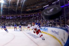 May 13, 2024; New York, New York, USA; New York Rangers defenseman K'Andre Miller (79) sends the puck around the boards against Carolina Hurricanes center Jesperi Kotkaniemi (82) during the first period of game five of the second round of the 2024 Stanley Cup Playoffs at Madison Square Garden. Mandatory Credit: Brad Penner-USA TODAY Sports