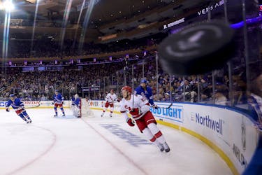 May 13, 2024; New York, New York, USA; New York Rangers defenseman K'Andre Miller (79) sends the puck around the boards against Carolina Hurricanes center Jesperi Kotkaniemi (82) during the first period of game five of the second round of the 2024 Stanley Cup Playoffs at Madison Square Garden. Mandatory Credit: Brad Penner-USA TODAY Sports