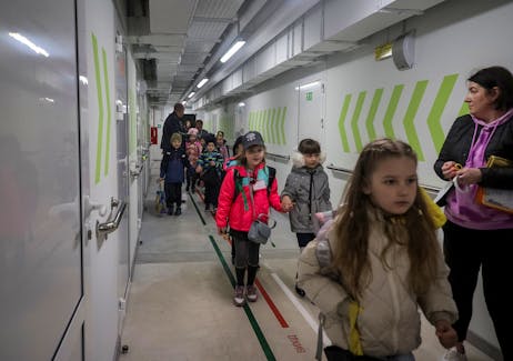Teachers and pupils walk to a classroom for a first lesson at the first heavily fortified underground school that allows children to safely return to in-person studies, amid Russia's attack on Ukraine, in Kharkiv, Ukraine May 13, 2024.