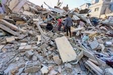 Palestinians search for casualties at the site of an Israeli strike on a house, amid the ongoing conflict between Israel and the Palestinian Islamist group Hamas, in Nuseirat refugee camp in the central Gaza Strip, May 14, 2024.