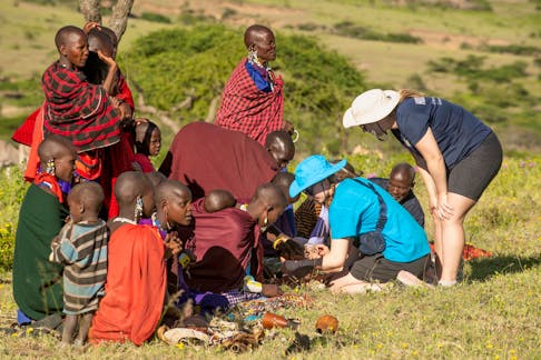 Grade 9 King’s-Edgehill School student Lillian Blois and Kelly Dietrich, a KES staff member, interact with Maasai women and children looking to sell their handmade jewellery. Many bracelets were purchased during the 21-day educational expedition in Tanzania.