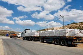 Trucks carrying aid to Gaza wait near a checkpoint near Hebron in the Israeli-occupied West Bank May 14, 2024.