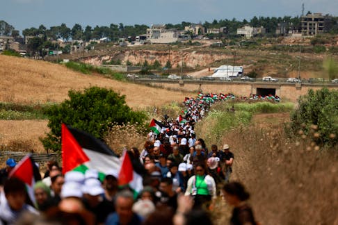 Palestinians living in Israel hold Palestinian flags as they take part in the annual Return March to mark the 76th anniversary of the Nakba, the "catastrophe" of their mass dispossession in the 1948 war surrounding Israel’s creation, near Haifa, in northern Israel, May 14, 2024.
