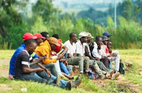 Job seekers wait beside a road for casual work offered by passing motorists in Eikenhof, south of Johannesburg, South Africa, March 4, 2024.