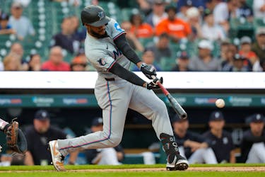May 13, 2024; Detroit, Michigan, USA; Miami Marlins outfielder Bryan De La Cruz (14) hits an RBI single in the fifth inning against the Detroit Tigers at Comerica Park. Mandatory Credit: Rick Osentoski-USA TODAY Sports