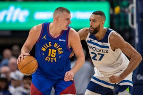 May 10, 2024; Minneapolis, Minnesota, USA; Denver Nuggets center Nikola Jokic (15) controls the ball as Minnesota Timberwolves center Rudy Gobert (27) defends in the second half during game three of the second round for the 2024 NBA playoffs at Target Center. Mandatory Credit: Jesse Johnson-USA TODAY Sports